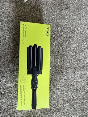 amika Black 3-Barrel Hair Waver on Neon Yellow Packaging